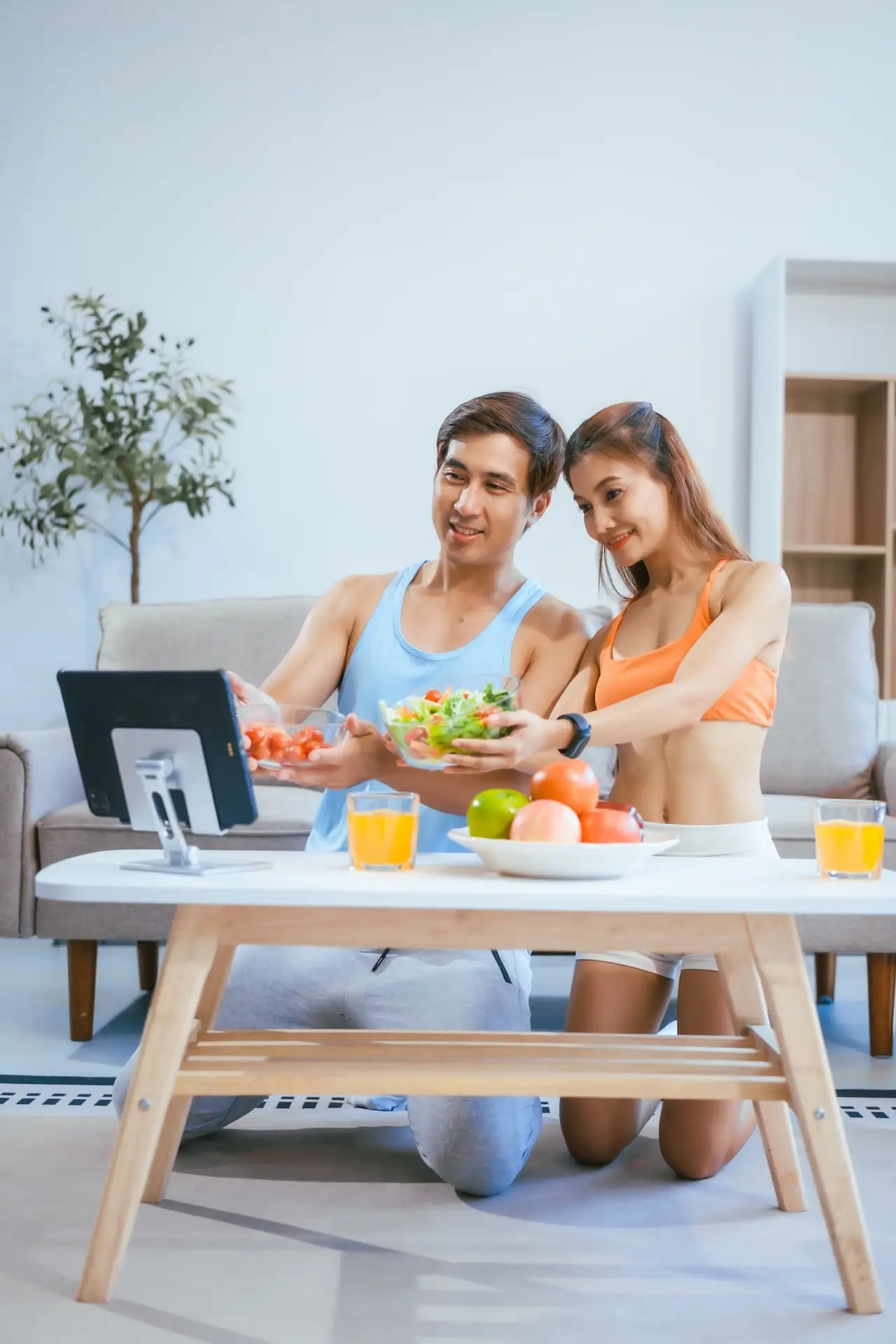 a-happy-young-couple-in-sportswear-sits-on-the-sof-2025-01-20-16-09-41-utc
