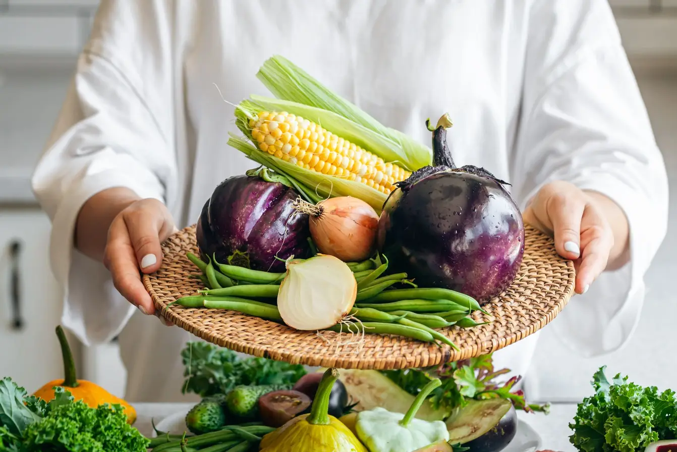 a-woman-holds-a-plate-with-eggplant-onion-corn-a-2023-11-27-05-20-29-utc (1)