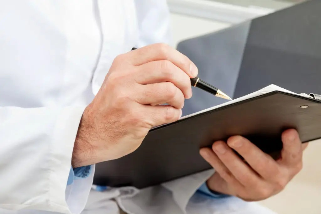 Voedselinspecteur of chef die notities maakt op een clipboard tijdens een HACCP-controle.